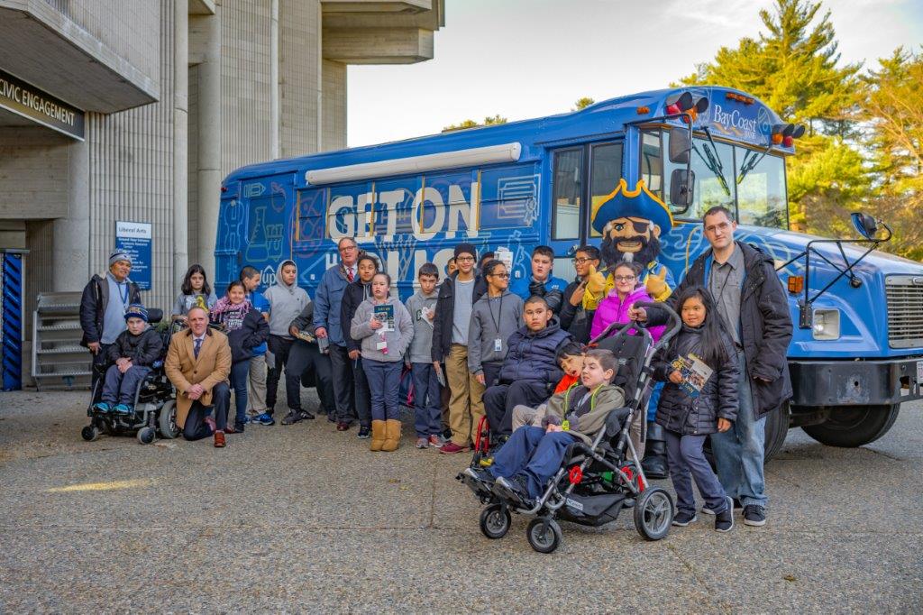 Picture of BayCoast Bank President and CEO Nicholas Christ with Fall River Public School system students and staff standing in front of bus - BayCoast Bank