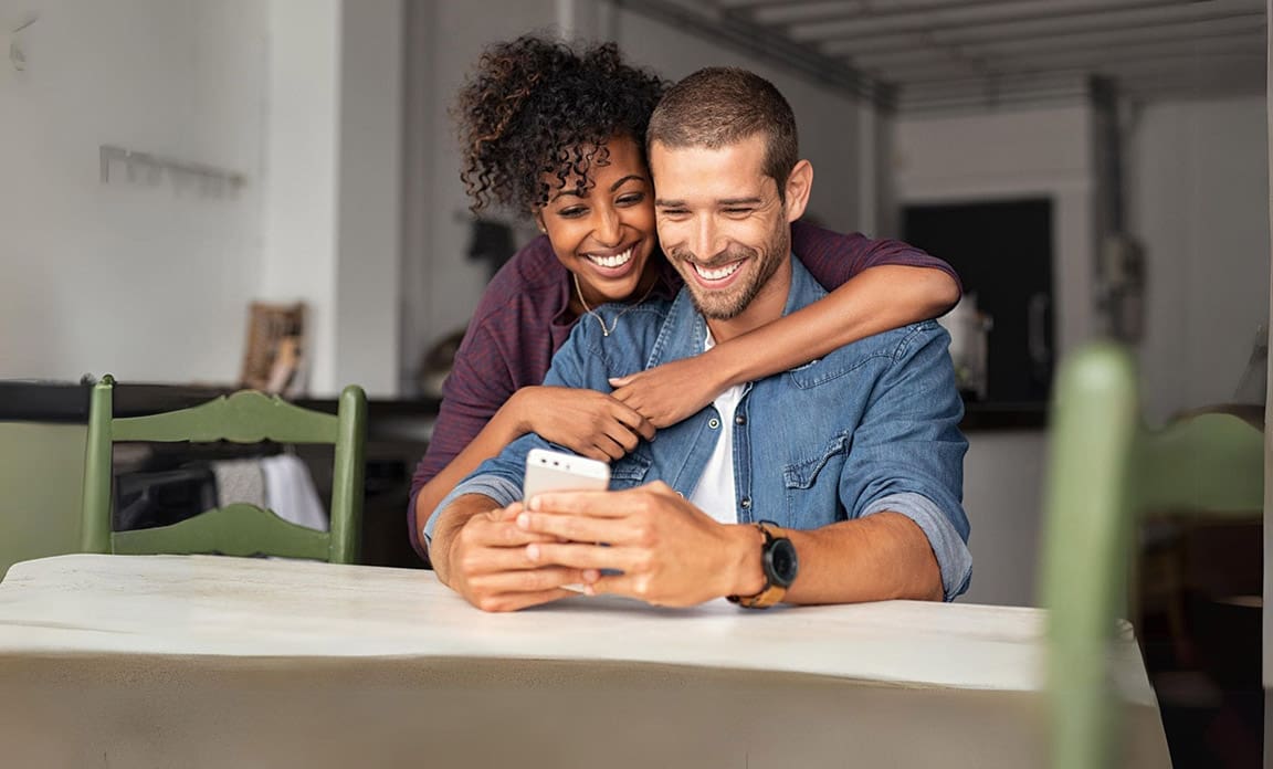 Girl Smiling at Laptop with card