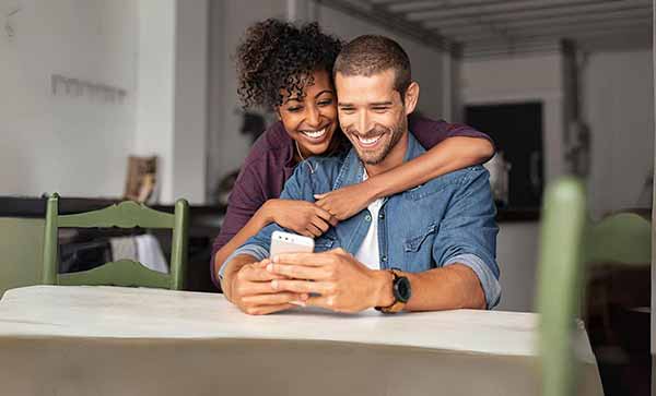Girl Smiling at Laptop with card